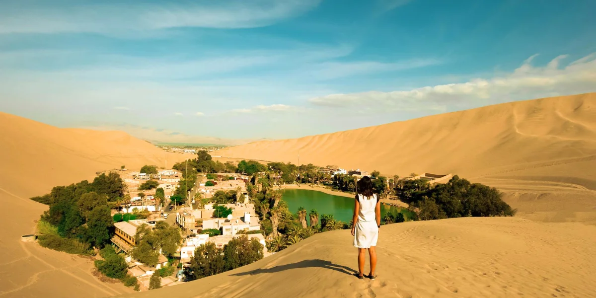 Huacachina oasis lagoon, natural water mirror in Ica desert, Peru
