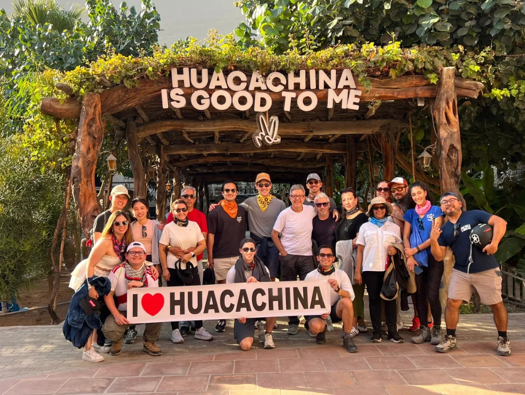 Group of travelers at the iconic Huacachina Oasis enjoying one of Peru’s top desert destinations.