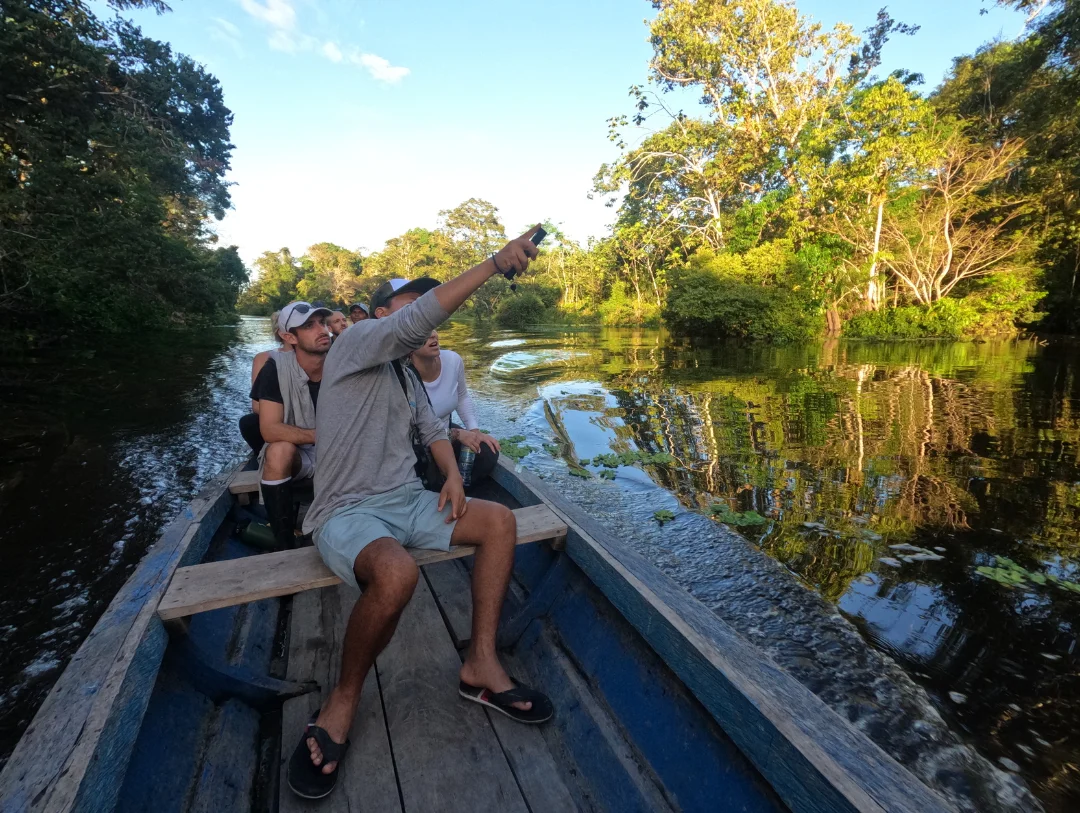 Travelers spotting wildlife on a relaxing 4 Day Manu National Park Tour by river boat