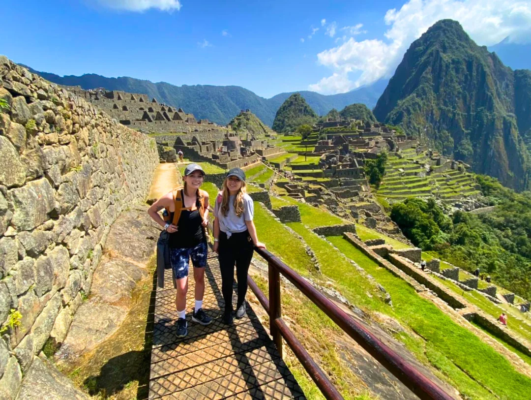 Visitors exploring Machu Picchu Citadel with spectacular mountain views