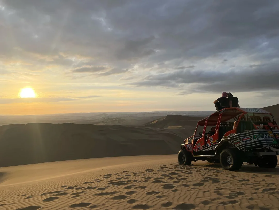 Sunset over the Huacachina dunes during the dune buggy adventure in Peru