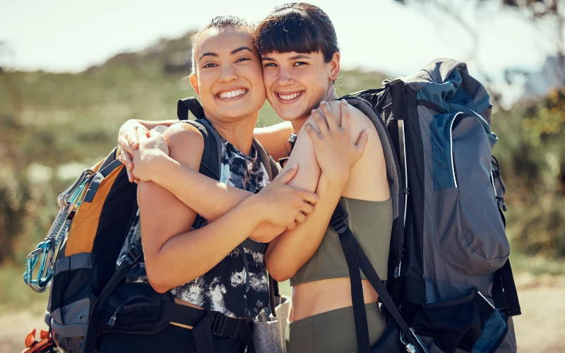 Happy travelers with backpacks enjoying a safe trip in Peru and exploring the country's top destinations