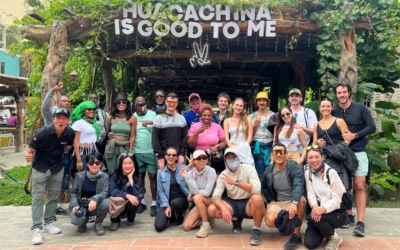 Travel group visiting Huacachina Oasis in Peru