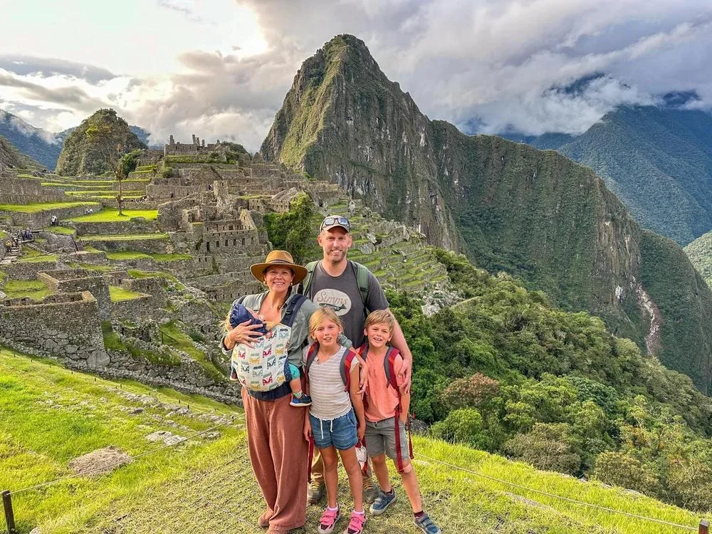 Family with children visiting Machu Picchu in Peru