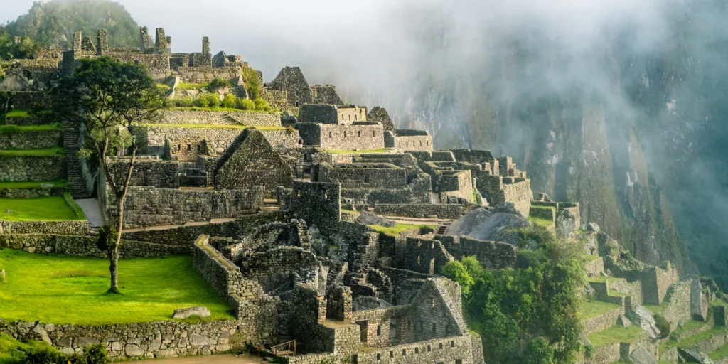 Machu Picchu citadel with Inca terraces and stone ruins surrounded by mountains in Peru