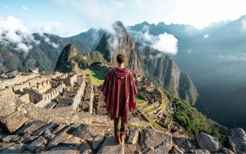 Machu Picchu in Peru with traveler overlooking the Inca ruins