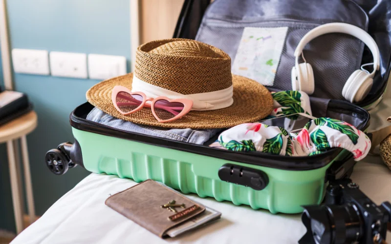 Packing for a trip to Peru with suitcase, hat and travel essentials