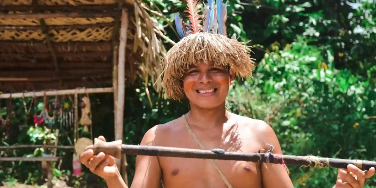 Indigenous Amazonian man demonstrating a traditional blowgun near Iquitos Peru