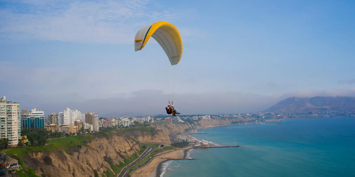 Paragliding over the Miraflores coastline and Pacific Ocean in Lima Peru