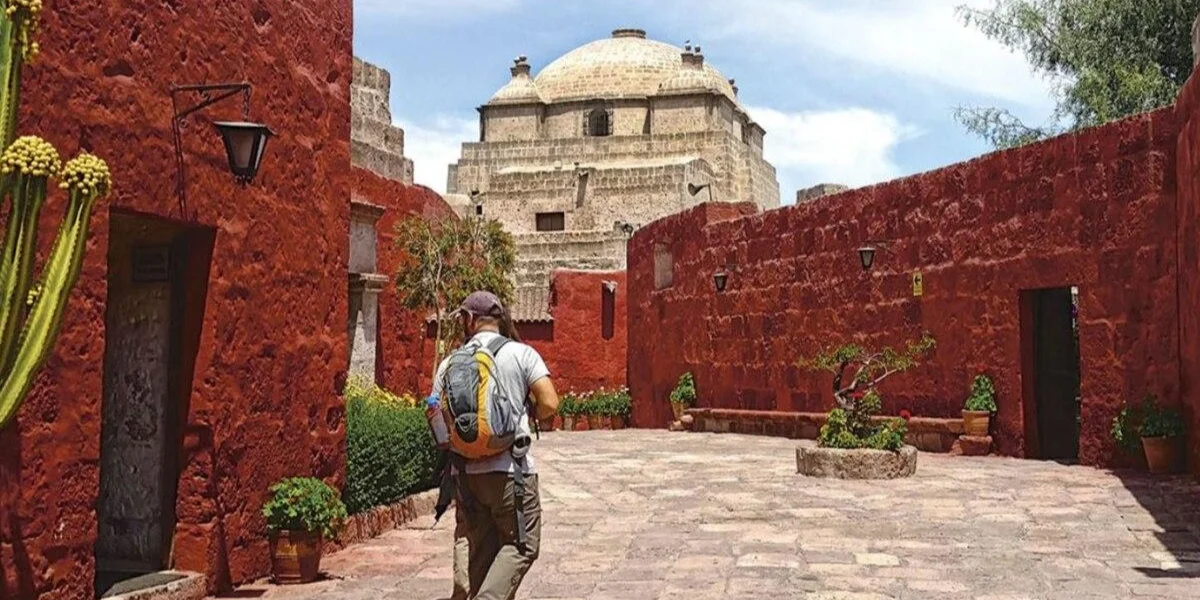 Traveler exploring the colorful streets of Santa Catalina Monastery in Arequipa Peru