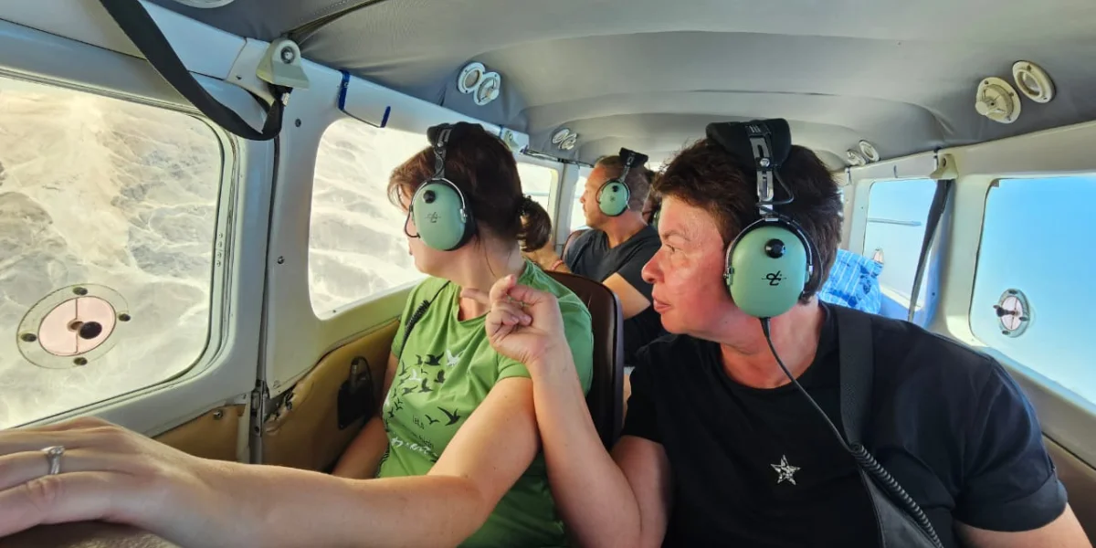 Travelers viewing the Nazca Lines from a small plane in Peru